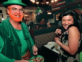 John Schauer giving a piece of chocolate to Mari Nito.